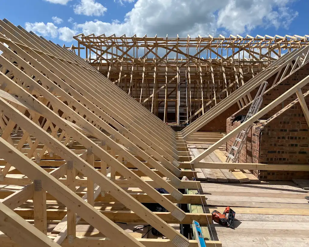 New timber roof trusses and rafters under construction