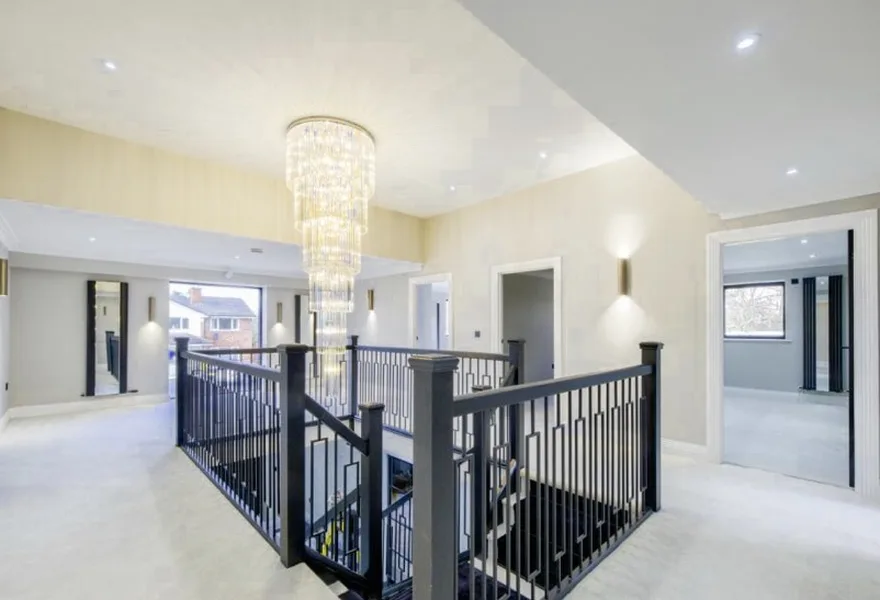 First floor landing with a chandelier and black balustrade
